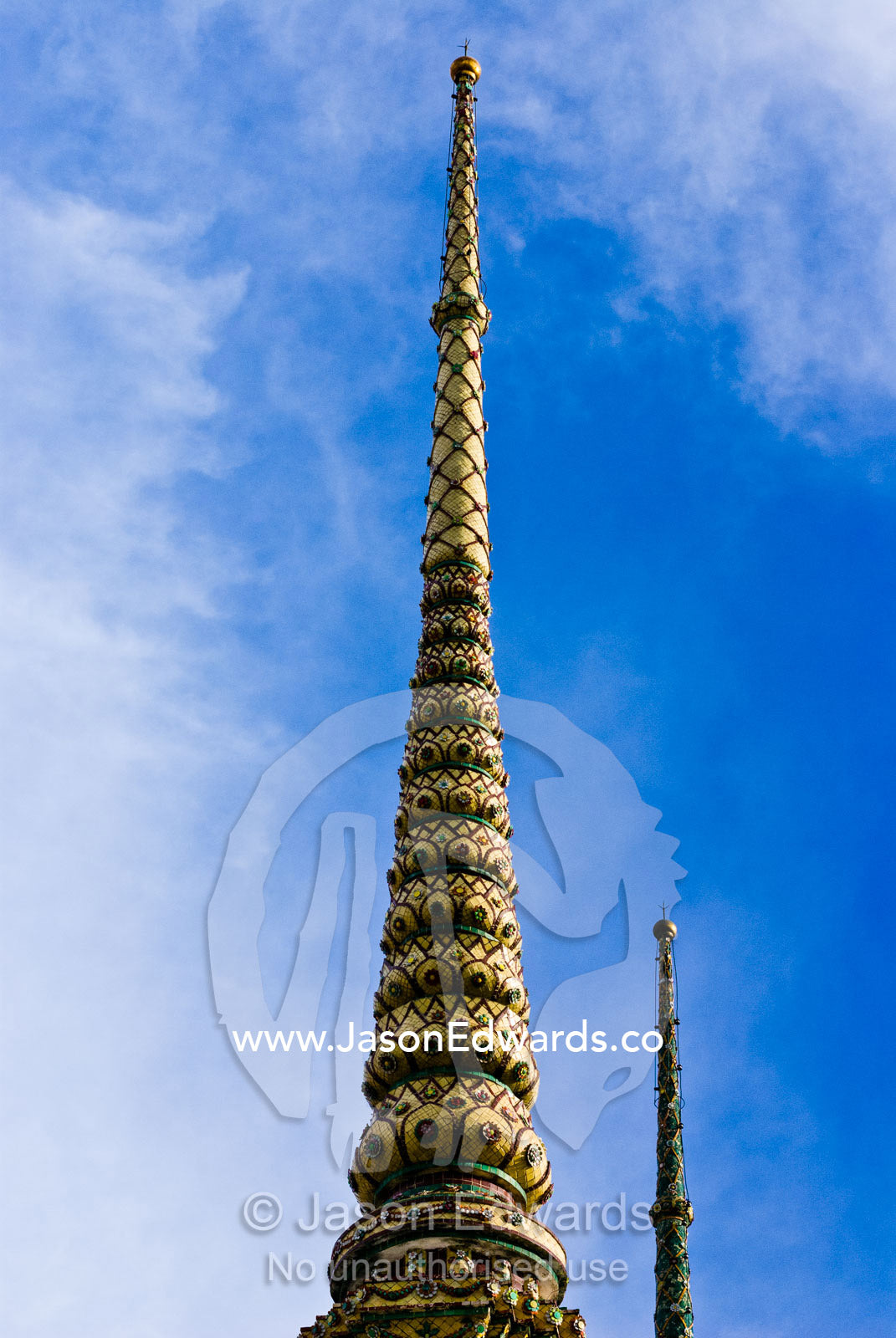 An ornately carved and decorated spire known as a prang atop a temple. Wat Pho, Temple of the Reclining Buddha, Wat Chetuphon, Phra Nakhon District, Rattanakosin District, Bangkok, Thailand.