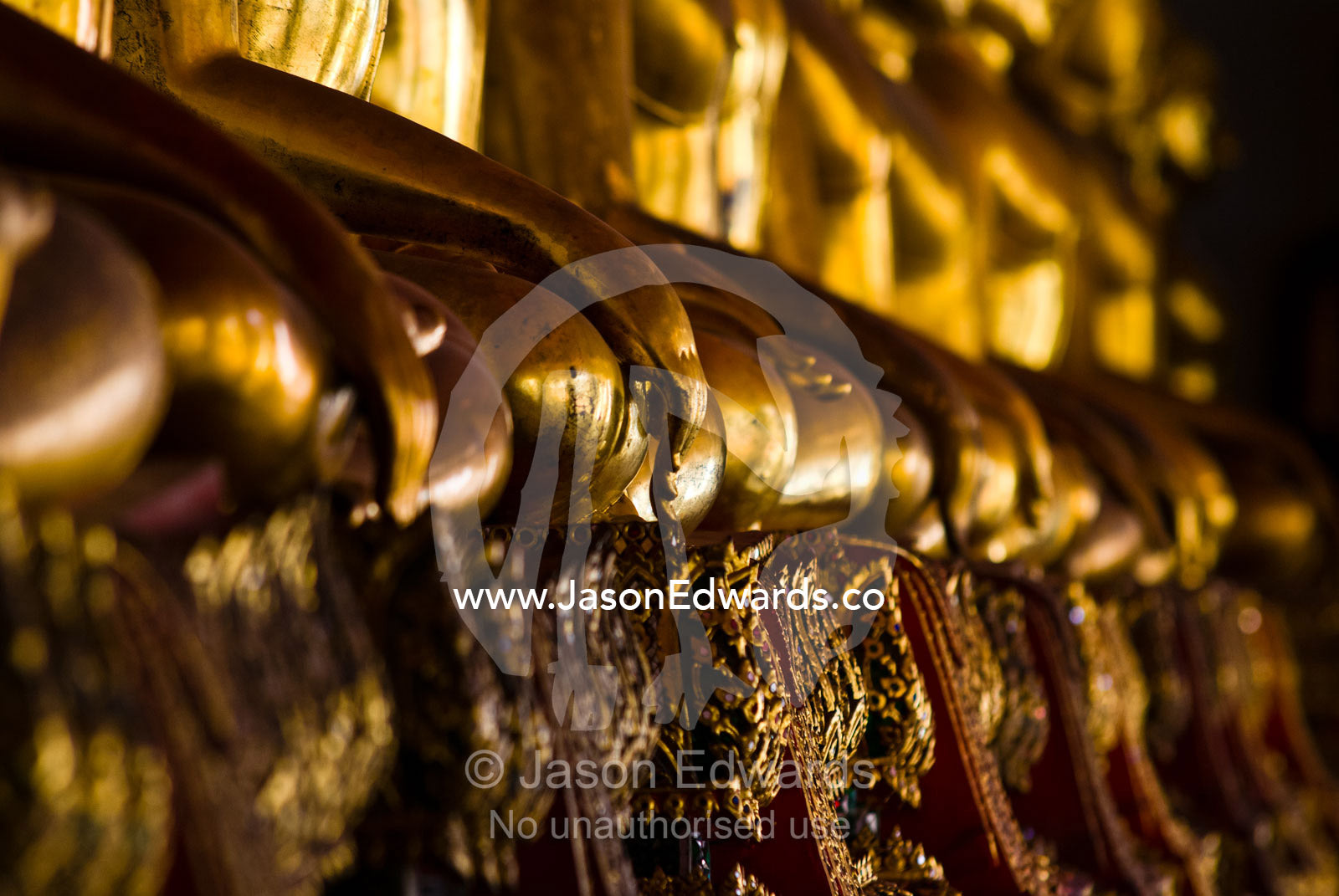A detail of the golden gilded hands of Buddha statues in a temple Wat Pho, Temple of the Reclining Buddha, Wat Chetuphon, Phra Nakhon District, Rattanakosin District, Bangkok, Thailand.