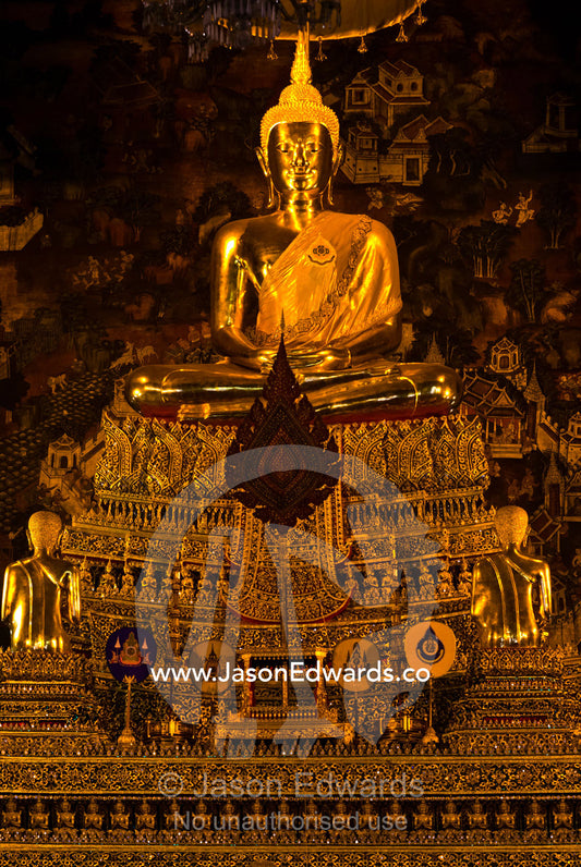 An enormous golden gilded statue of the Buddha seated in the Ubosot. Wat Pho, Temple of the Reclining Buddha, Wat Chetuphon, Phra Nakhon District, Rattanakosin District, Bangkok, Thailand.