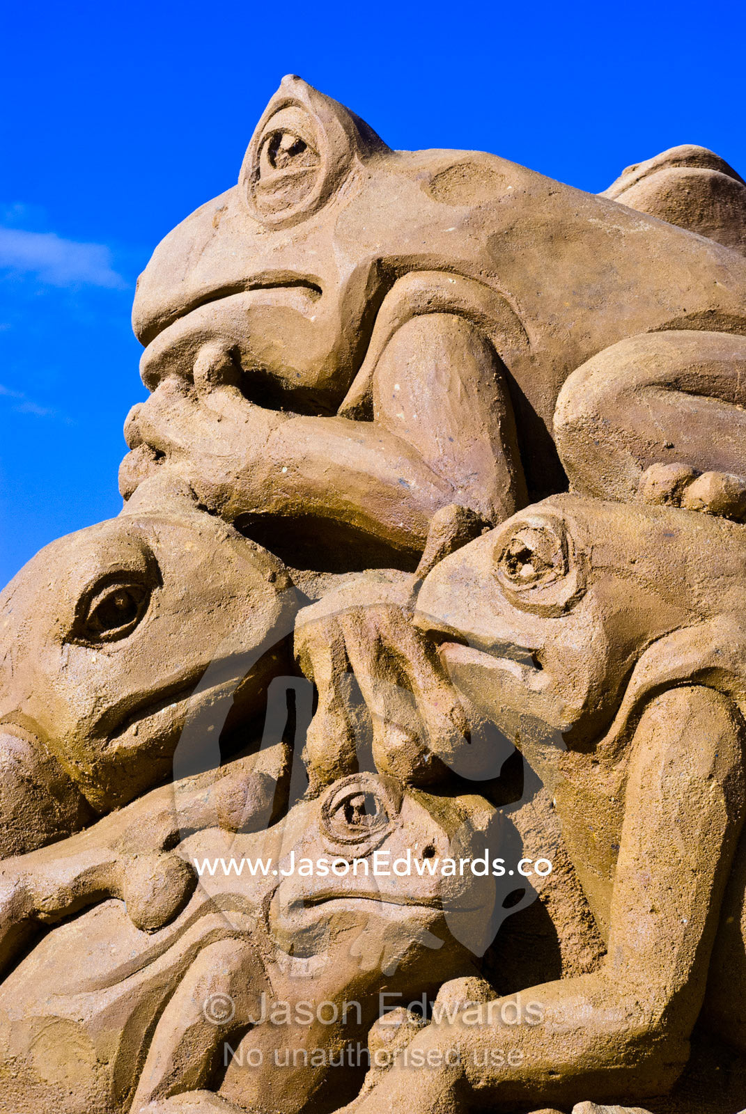 A professional sand sculpture featuring a pile of Green Tree Frogs. Frankston, Port Phillip Bay, Melbourne, Victoria, Australia.