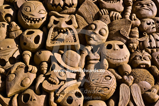 Tim Burton inspired sand sculpture, 'A Closer Look' features death faces. Frankston, Port Phillip Bay, Melbourne, Victoria, Australia.
