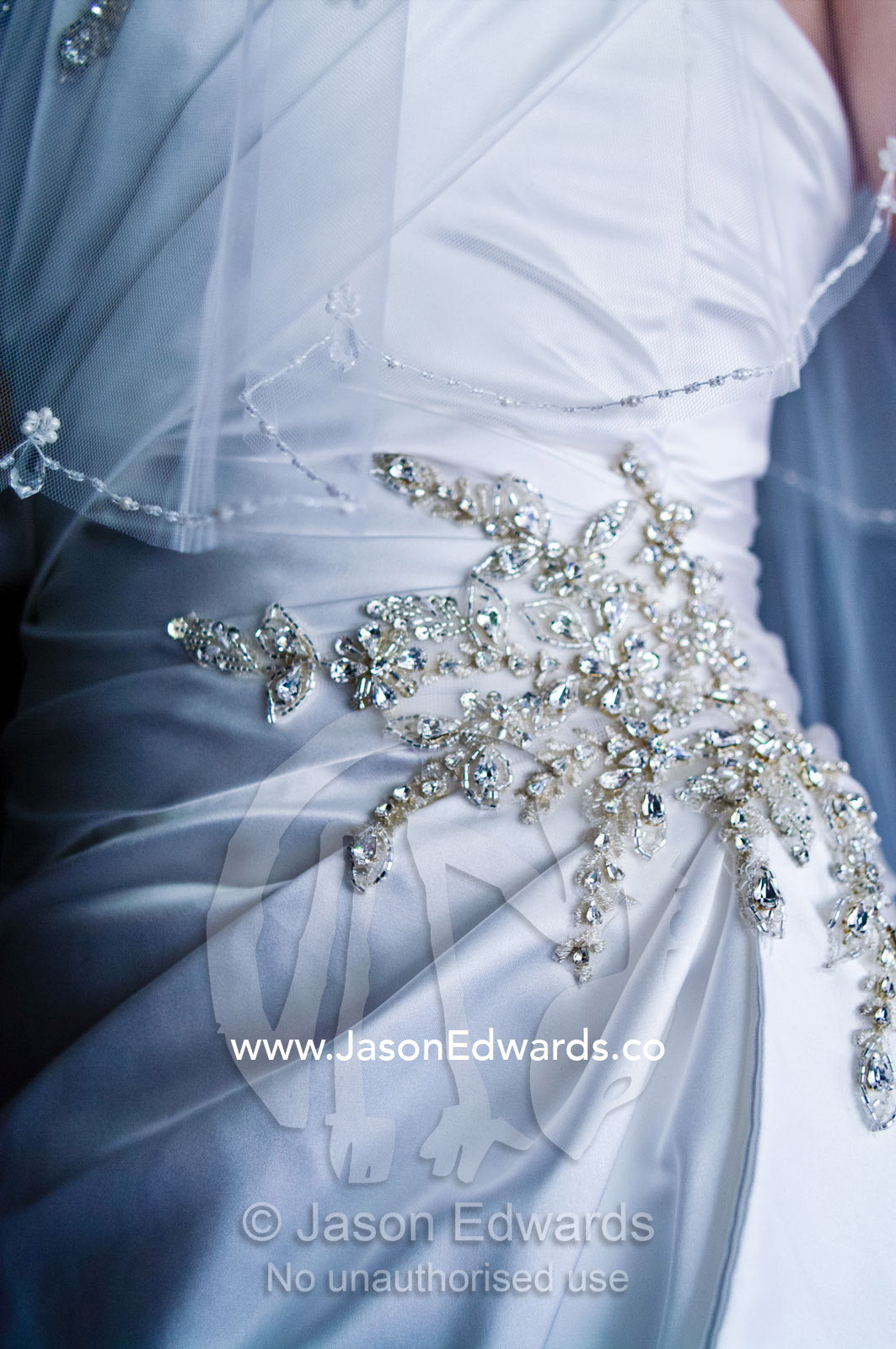 Ornate diamante applique on the gathered waist of a satin bridal gown Park Orchards, Melbourne, Victoria, Australia.