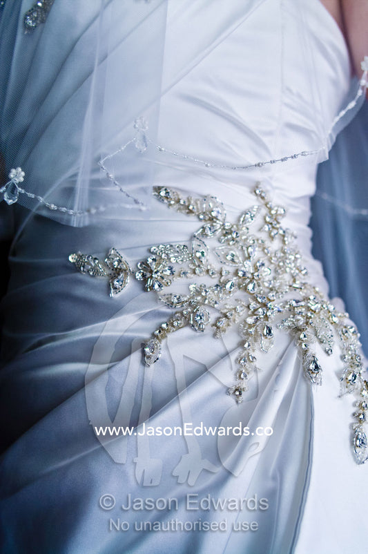 Ornate diamante applique on the gathered waist of a satin bridal gown Park Orchards, Melbourne, Victoria, Australia.