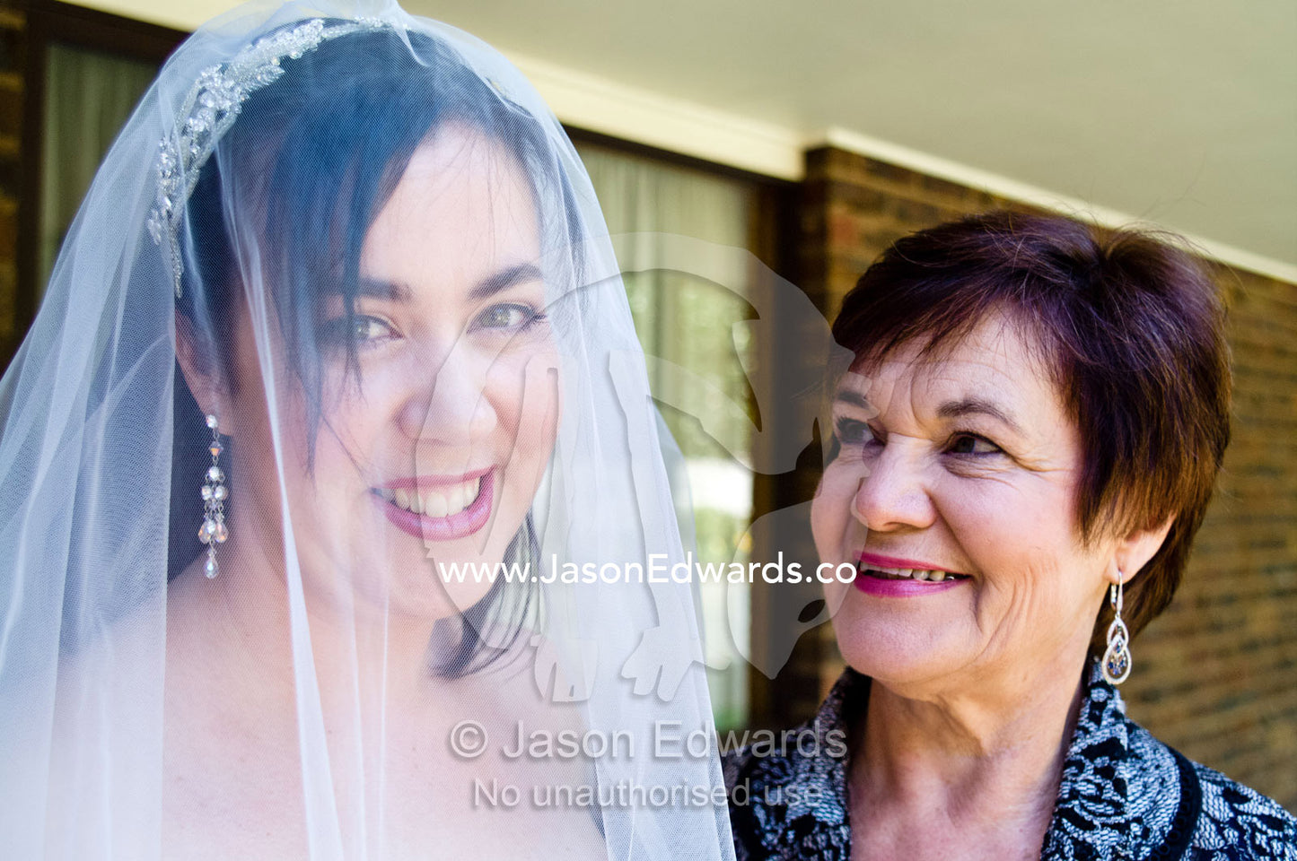 A glowing bride in her veil with her proud mother on her wedding day. Park Orchards, Melbourne, Victoria, Australia.