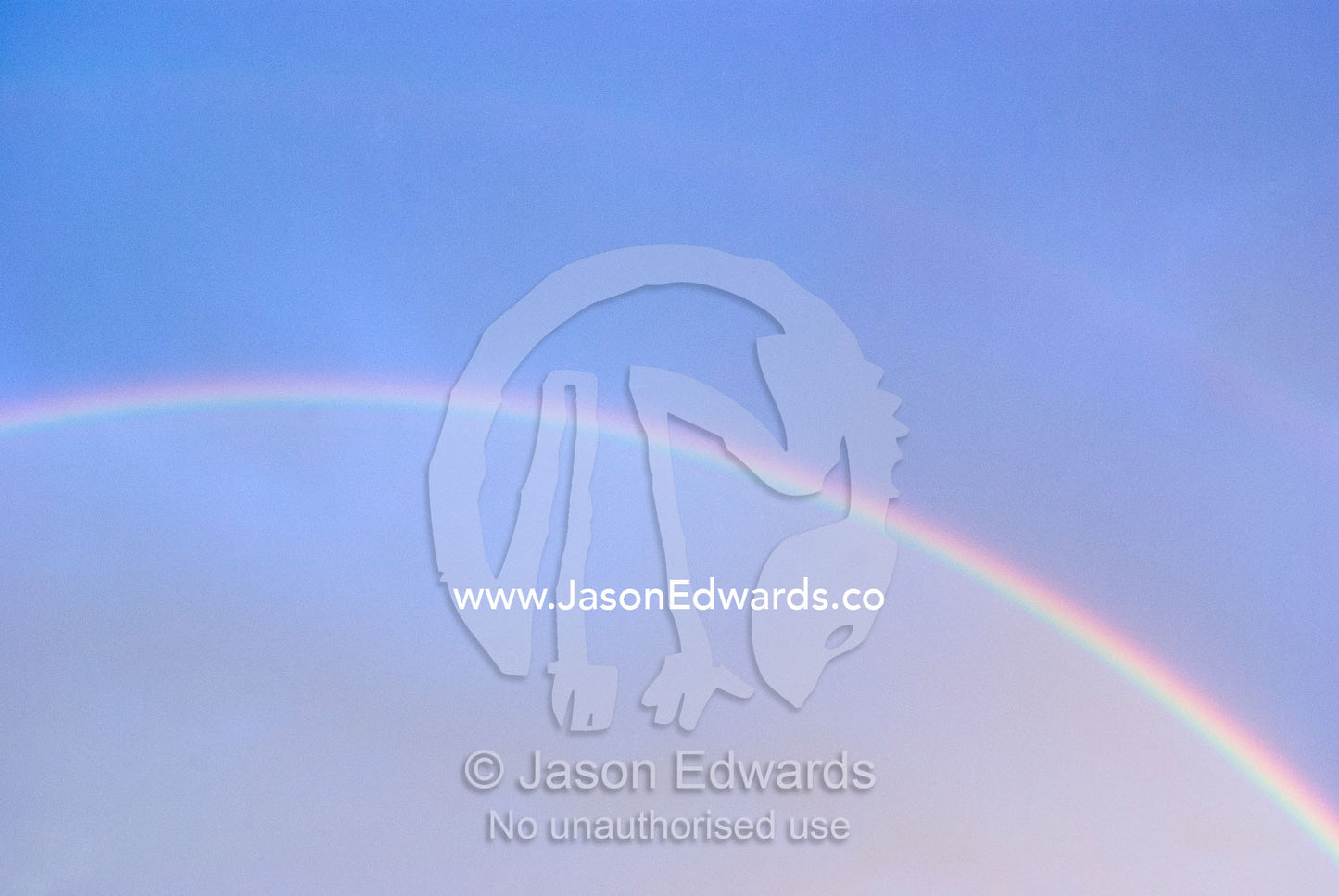 The prism of an iridescent rainbow arching through a stormy sky. North Carlton, Melbourne, Victoria, Australia.