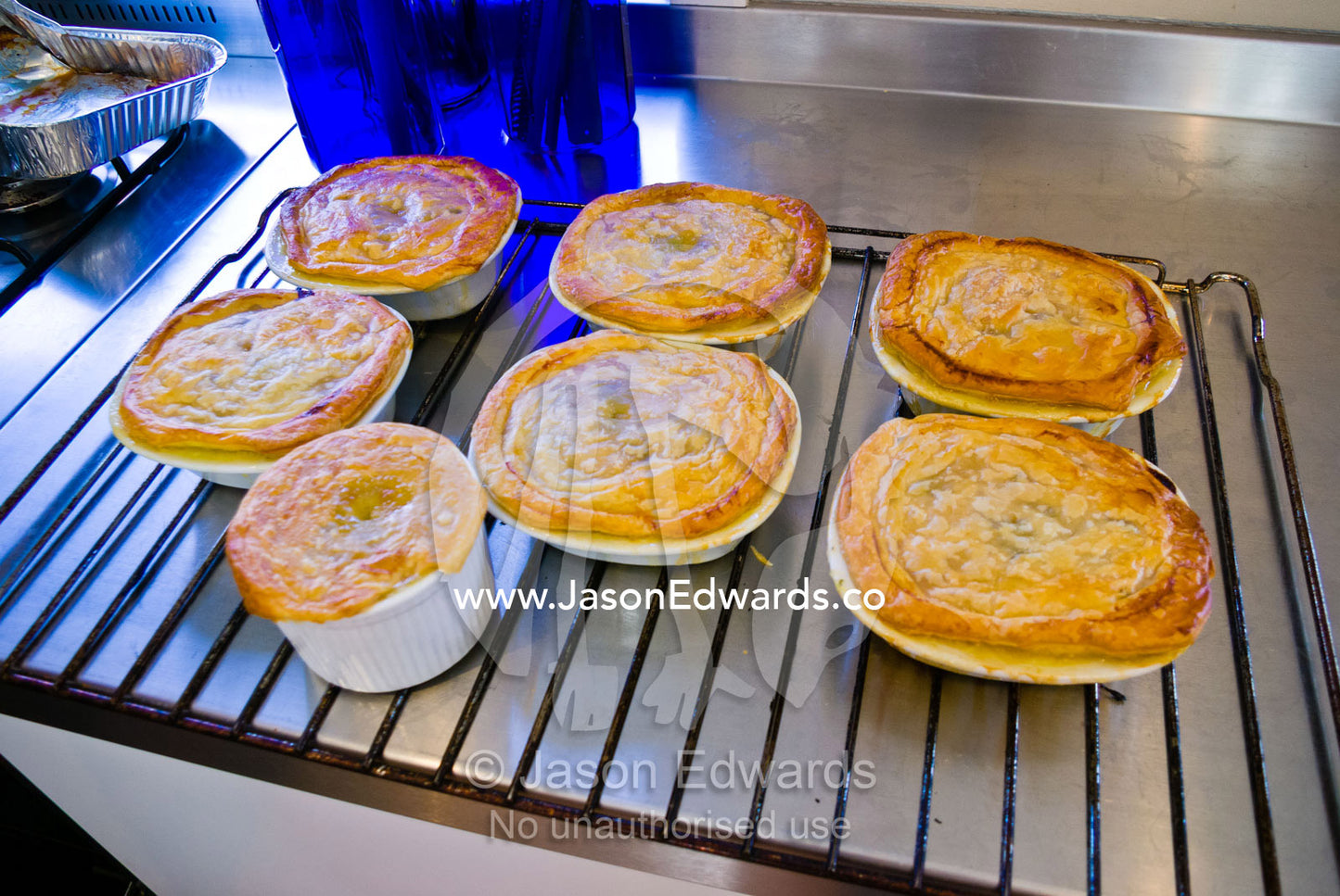 Freshly baked chicken pies cooling on an oven rack in a kitchen. Malvern East, Melbourne, Victoria, Australia.