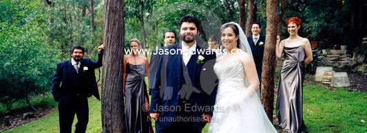 A bride and groom pose with their bridal party at the garden wedding. Park Orchards, Melbourne, Victoria, Australia.