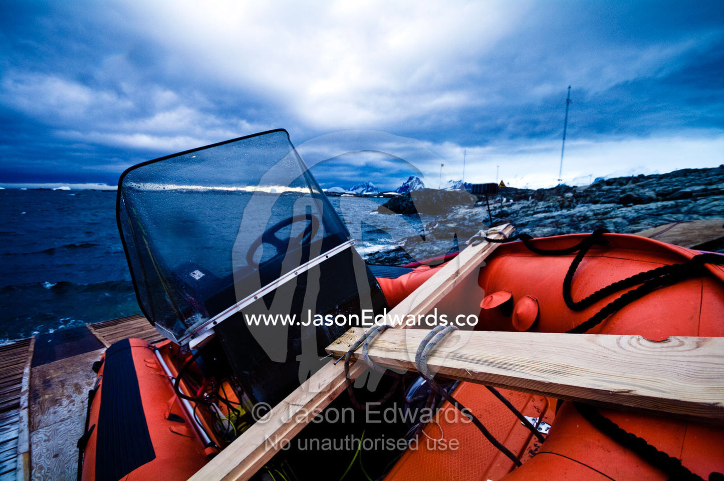 An inflatable boat beached on a rocky shore near a research station. Vernadsky Antarctic Research Base, Galindez Island, Argentine Islands, Faraday Islands, Antarctic Peninsula, Antarctica.