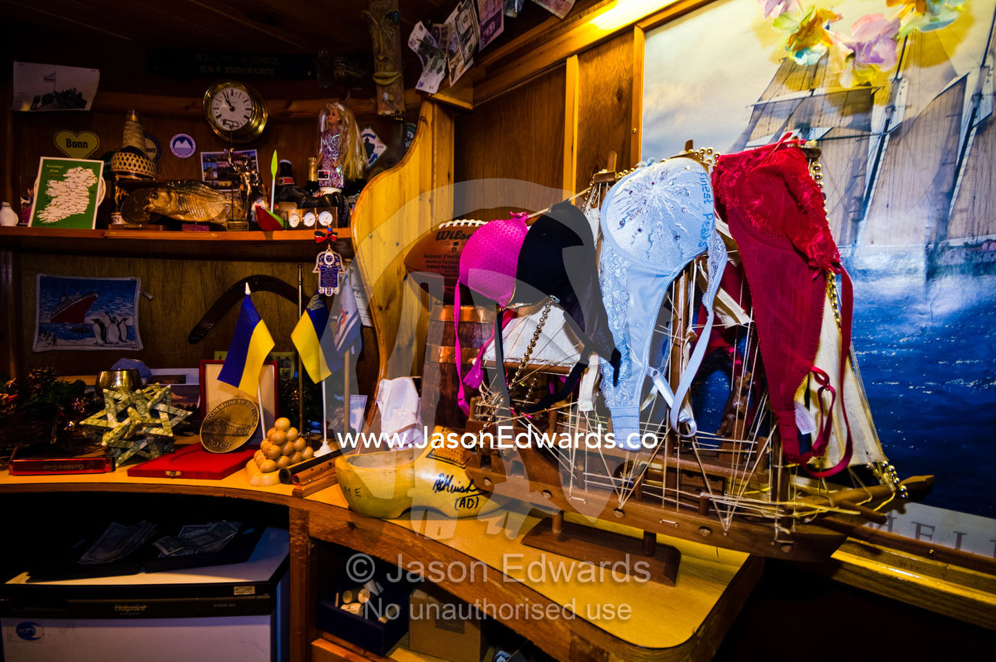 Bras draped over a model wooden ship in the bar of a research station. Vernadsky Antarctic Research Base, Galindez Island, Argentine Islands, Faraday Islands, Antarctic Peninsula, Antarctica.