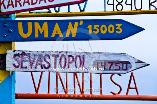 A directional sign at a Ukrainian station points to distant cities. Vernadsky Antarctic Research Base, Galindez Island, Argentine Islands, Faraday Islands, Antarctic Peninsula, Antarctica.
