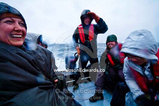 Tourists enjoy wild weather and rough seas in a zodiac in Antarctica. Pl��neau and Booth Islands, Bellingshausen Sea, Antarctic Peninsula, Antarctica.
