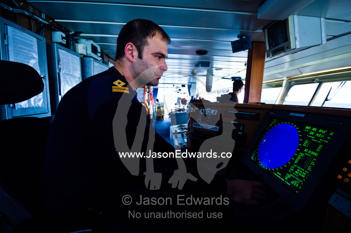 A officer on the bridge as the ship rounds treacherous Cape Horn. Drake Passage, Cape Horn, Tierra del Fuego, Hornos Island, Chile.