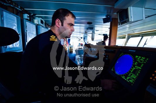 A officer on the bridge as the ship rounds treacherous Cape Horn. Drake Passage, Cape Horn, Tierra del Fuego, Hornos Island, Chile.