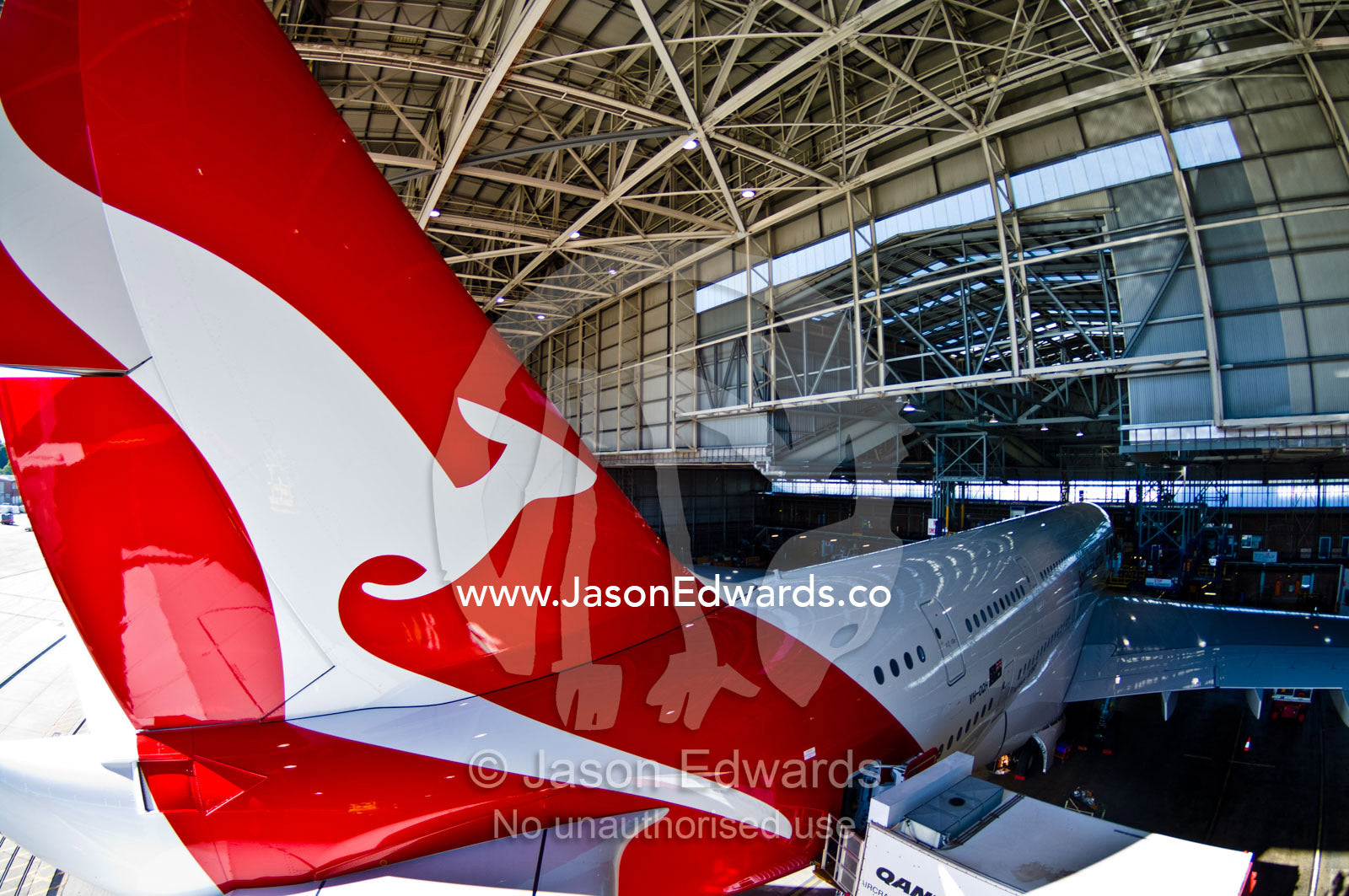 A kangaroo logo on a jet airliner parked in a hanger for repairs. Kingsford Smith Airport, Mascot, Sydney, New South Wales, Australia.