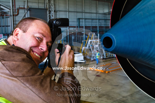 A photographer captures images of a jet airliner engine exhaust. Kingsford Smith Airport, Mascot, Sydney, New South Wales, Australia.