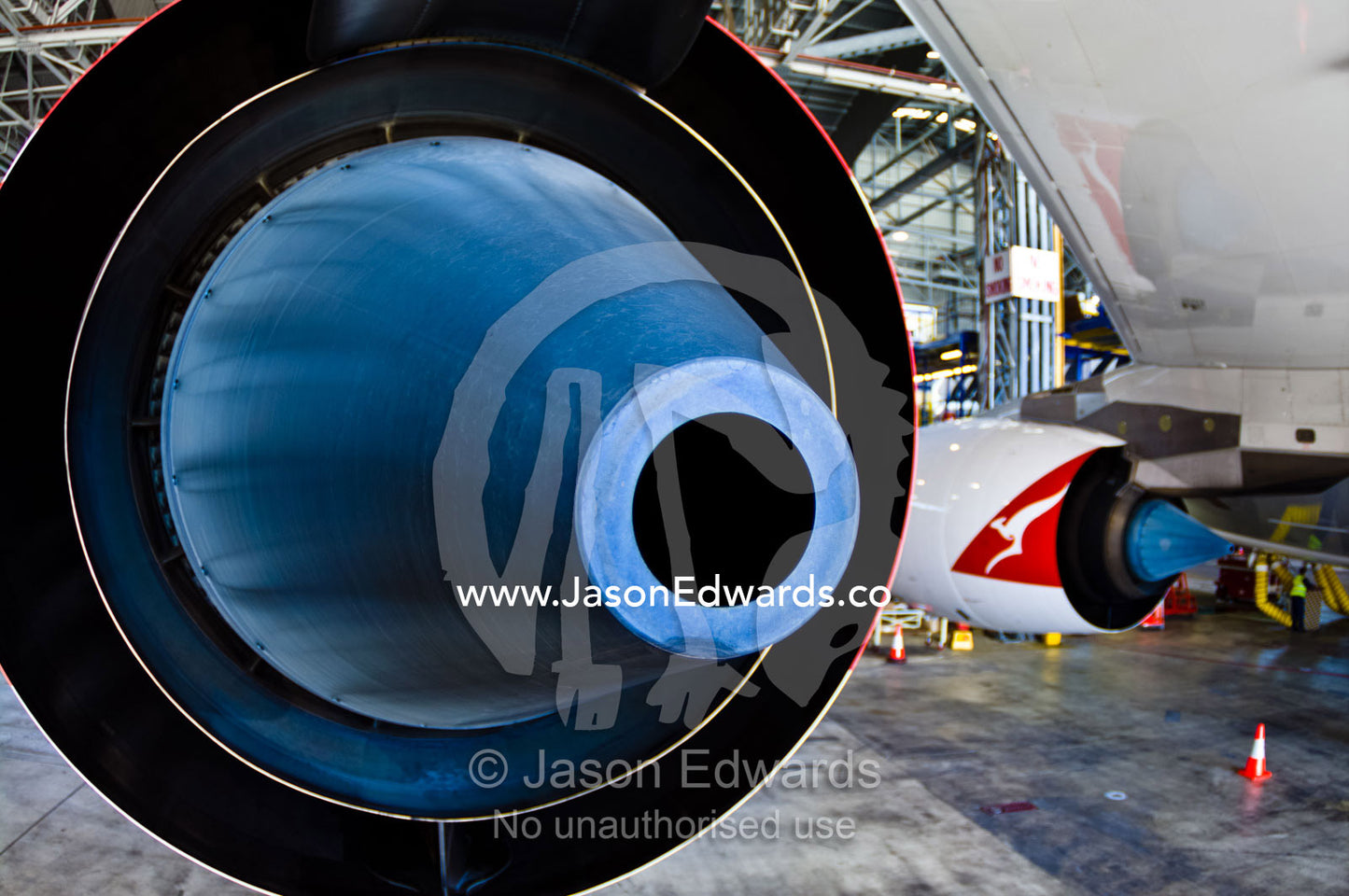 The blue titanium exhaust cone of a Rolls Royce A380 jet engine. Kingsford Smith Airport, Mascot, Sydney, New South Wales, Australia.