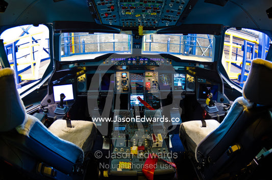 The flight controls and LED screens in the cockpit of a jet airliner. Kingsford Smith Airport, Mascot, Sydney, New South Wales, Australia.