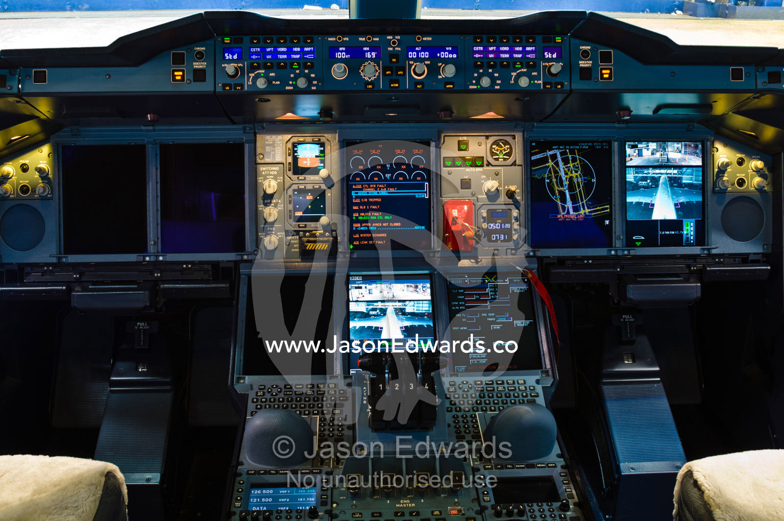 The flight controls and LED screens in the cockpit of a jet airliner. Kingsford Smith Airport, Mascot, Sydney, New South Wales, Australia.