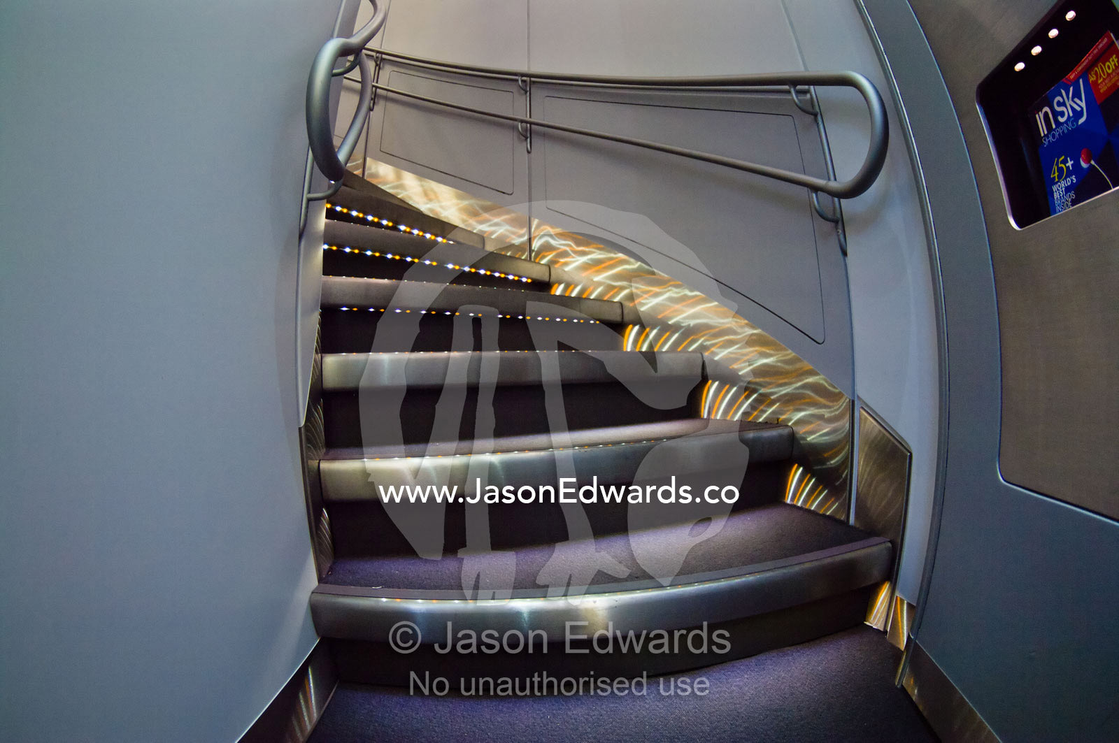 LED lighting on stainless steel steps leading to business class. Kingsford Smith Airport, Mascot, Sydney, New South Wales, Australia.