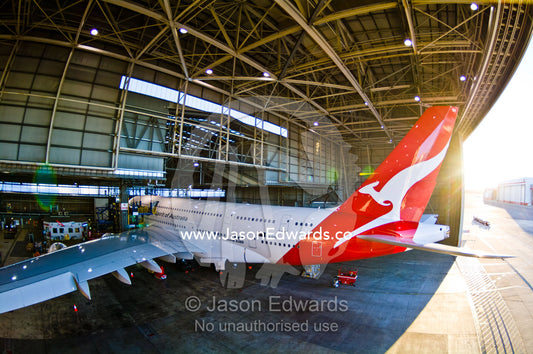 Jet airliner garaged in an airport hangar for repairs and maintenance. Kingsford Smith Airport, Mascot, Sydney, New South Wales, Australia.