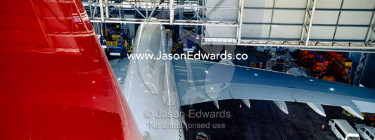 Jet airliner garaged in an airport hangar for repairs and maintenance. Kingsford Smith Airport, Mascot, Sydney, New South Wales, Australia.