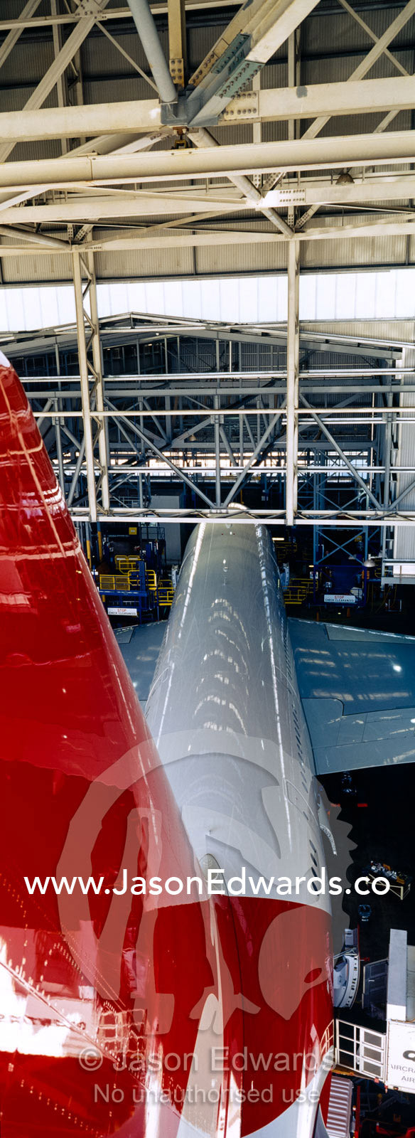 Jet airliner garaged in an airport hangar for repairs and maintenance. Kingsford Smith Airport, Mascot, Sydney, New South Wales, Australia.