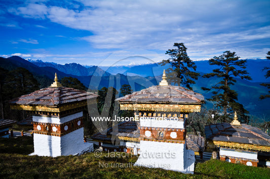 A group of chortens overlook the Himalaya from a mountaintop. 108 Druk Wangyal Khangzang Chortens, Dochula Pass, Thimphu District, Bhutan.