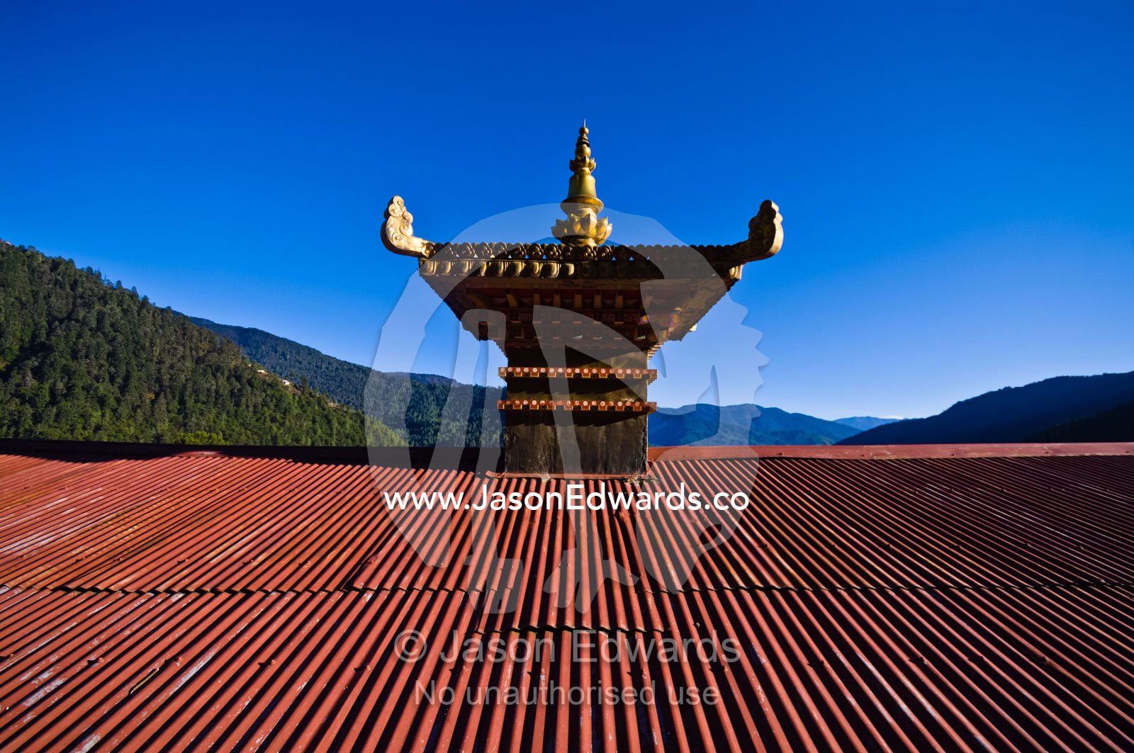 The golden sertog, a pinnacle, atop the roof of a Buddhist monastery. Cheri Monastery, Chagri Dorjeden Monastery, Thimphu, Thimphu District, Bhutan.