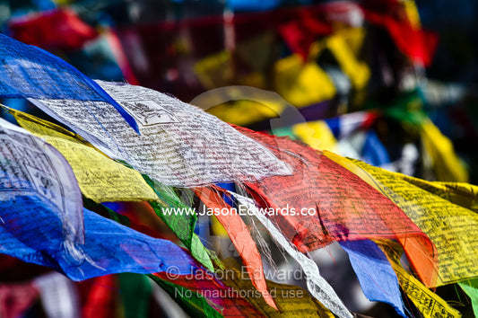 Colorful prayer flags flutter in the wind on a Himalayan mountain. 108 Druk Wangyal Khangzang Chortens, Dochula Pass, Thimphu District, Bhutan.