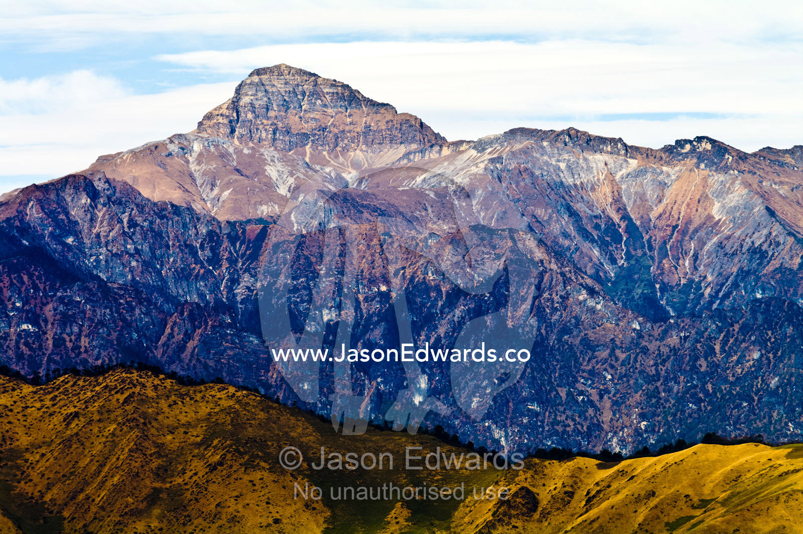 A sheer and rugged Himalaya mountain peak free from snow and ice due to global warming. Punakha District, Bhutan.
