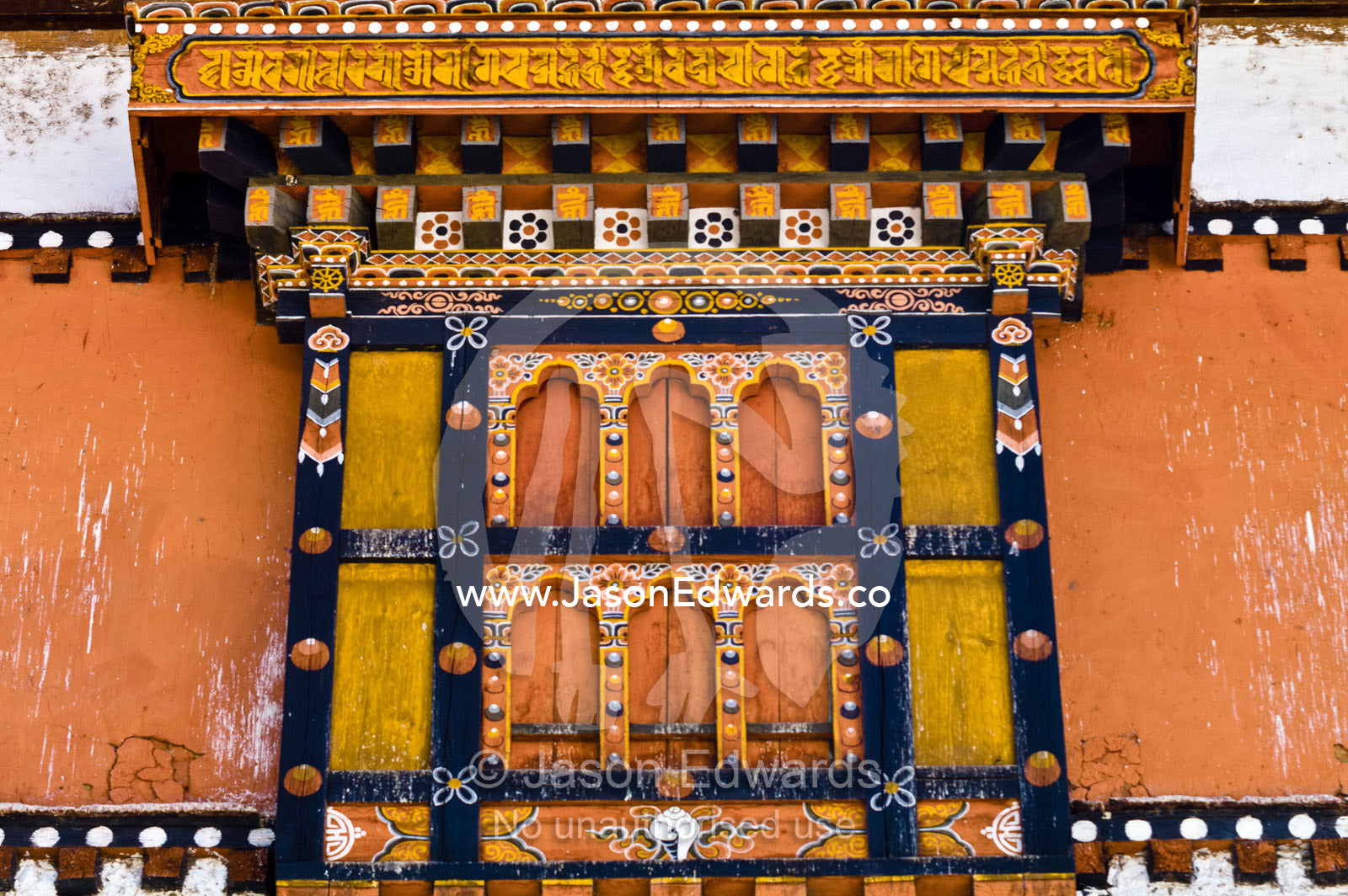 Ornately carved and painted window shutters on a Buddhist monastery. Rinpung Dzong, Paro Dzong, Paro, Paro District, Bhutan.