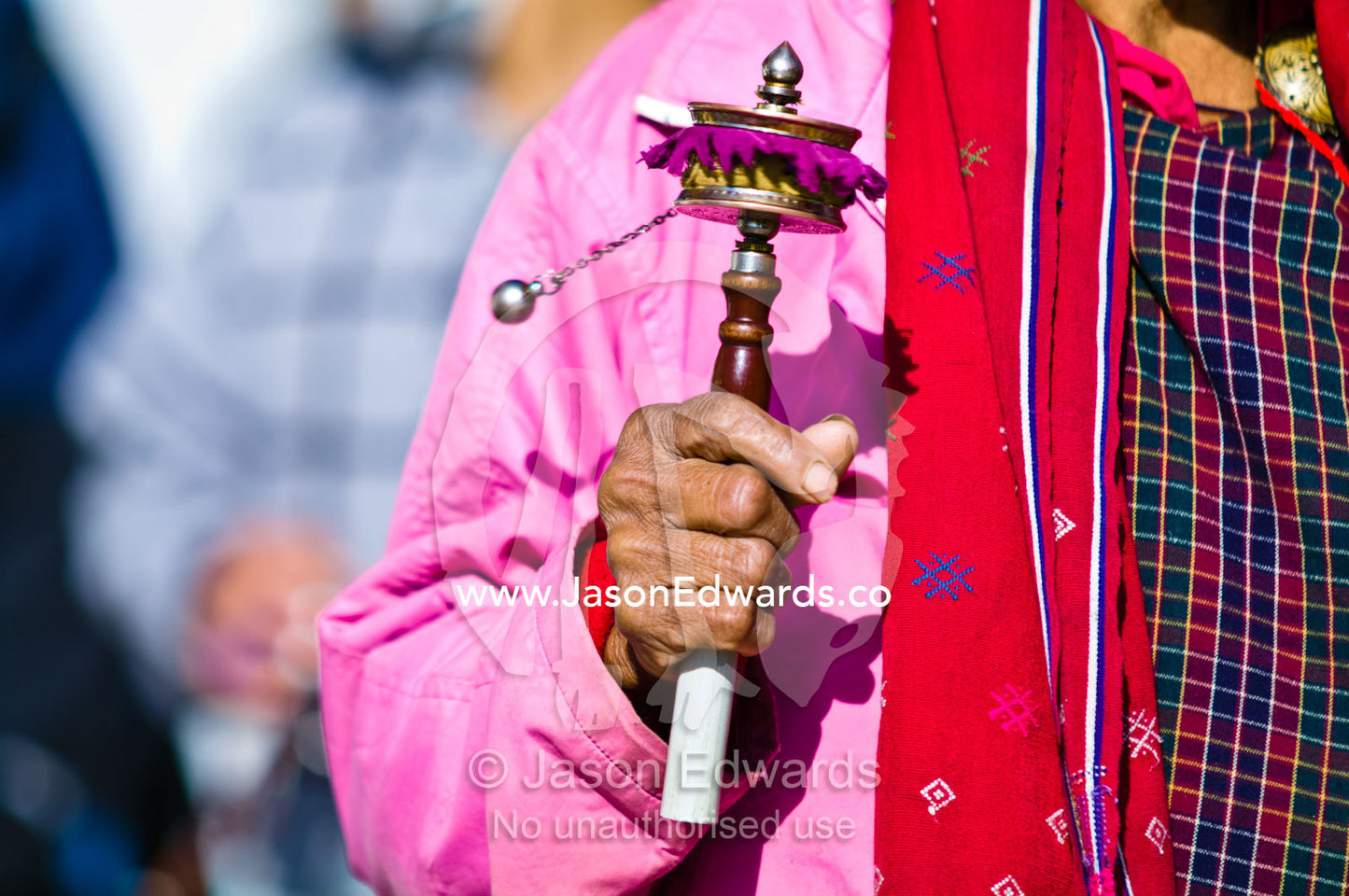 An elderly lady walks in circles around the Thimphu Memorial Chorten spinning her prayer wheel. Thimphu Memorial Chorten, Thimphu, Bhutan.