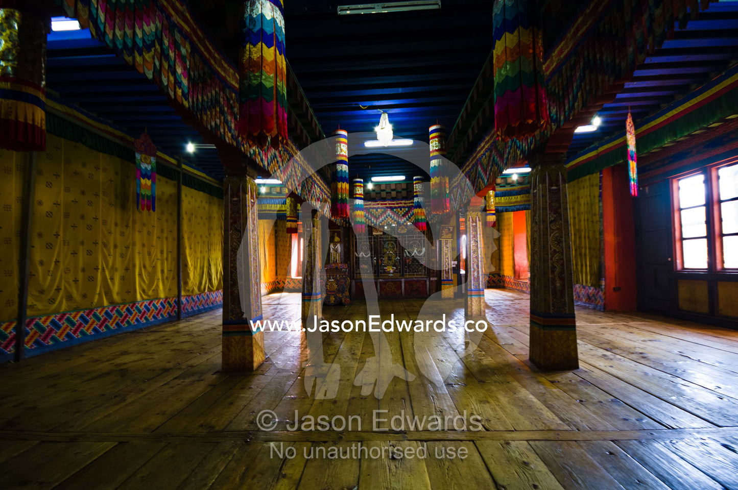 The ancient timber floor and columns in a prayer hall in a Buddhist monastery. Rinpung Dzong, Paro Dzong, Paro, Paro District, Bhutan.