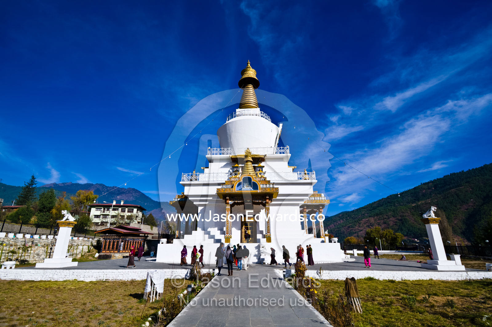 Pilgrims circle the Memorial Chorten with it's golden spire and bells offering prayers. Thimphu Memorial Chorten, Thimphu Bhutan.