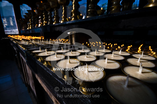 Rows of butter lamps waiting to be lit for prayers and aspirations at the memorial Chorten. Thimphu Memorial Chorten, Thimphu, Bhutan.