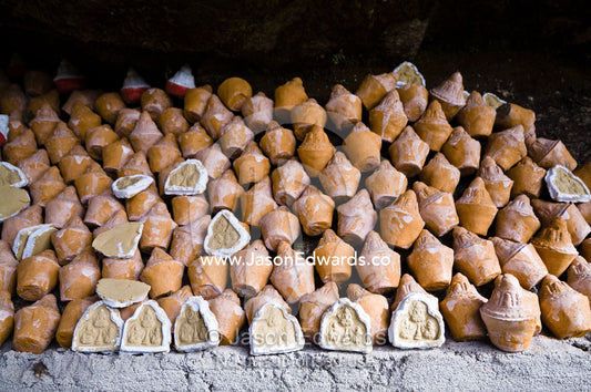 People place reliquaries or religious tsa tsa on a cliff in a Himalaya valley in memory of deceased loved ones. Dochula Pass, Thimphu District, Bhutan.