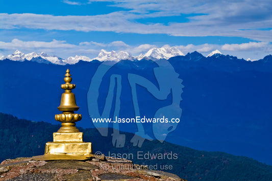 The golden cupola spire on a chorten faces the snowy Himalaya peaks. 108 Druk Wangyal Khangzang Chortens, Dochula Pass, Thimphu District, Bhutan.