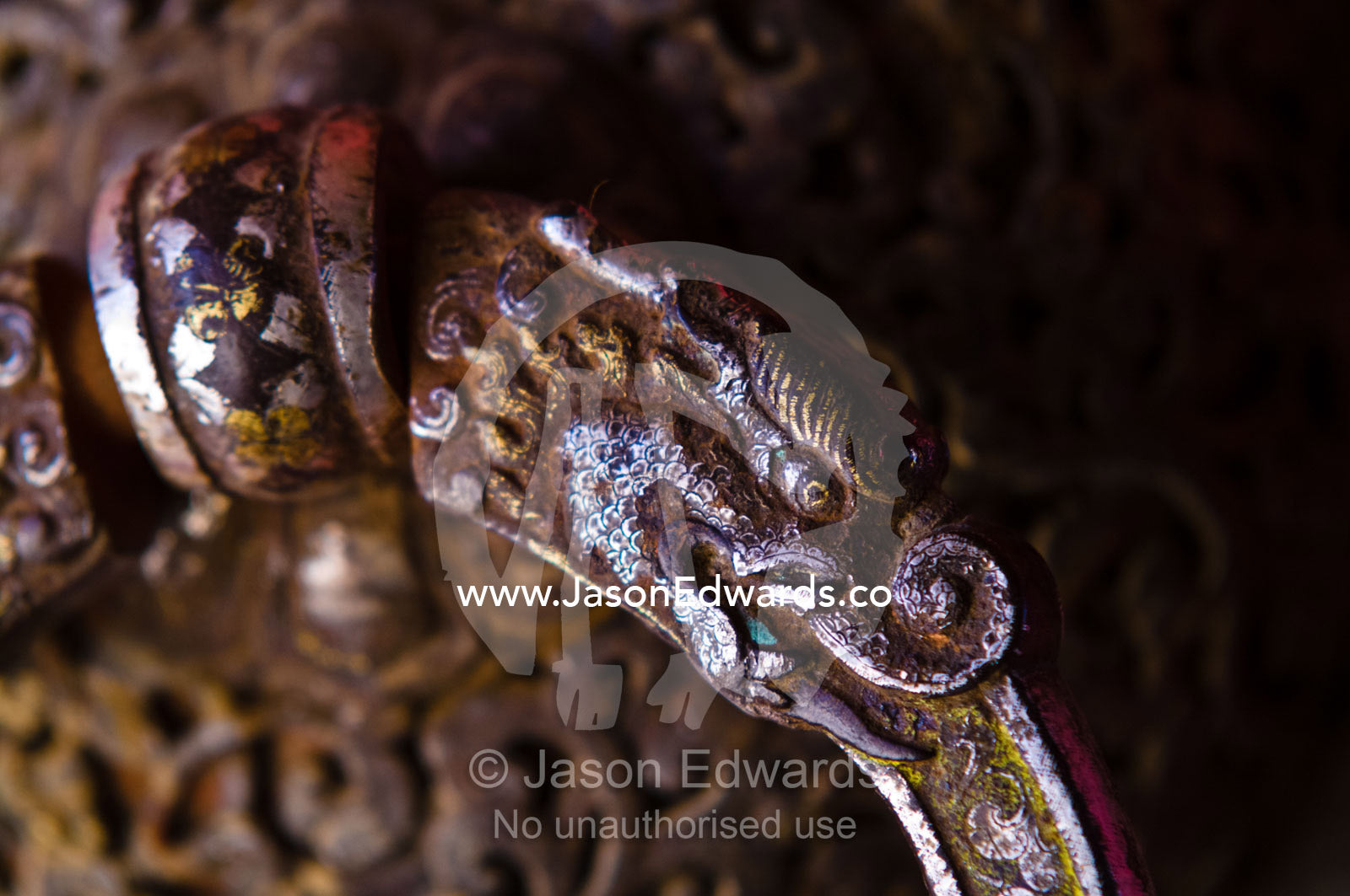 A Druk, Thunder Dragon on a large metal door knocker at the entrance to a Buddhist monastery. Gangteng Monastery, Ganteng, Wangdue Phodrang District, Phobjika Valley, Phobjikha Valley, Gangteng Valley, Black Mountains, Bhutan.