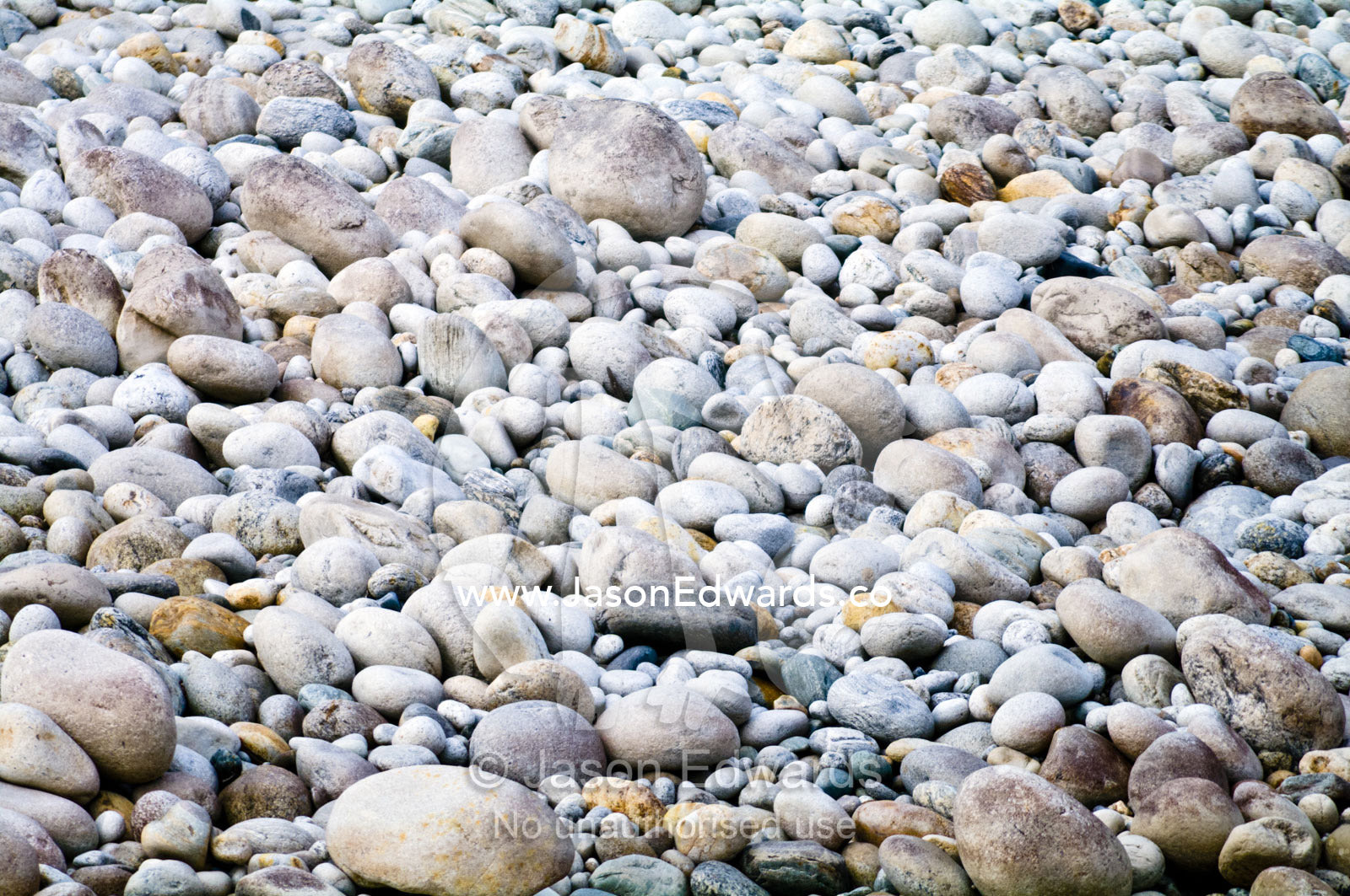 A pebble and boulder strewn riverbank in a Himalaya valley. Punakha River, Punakha Valley, Punakha-Wangdiphodrang District, Bhutan.