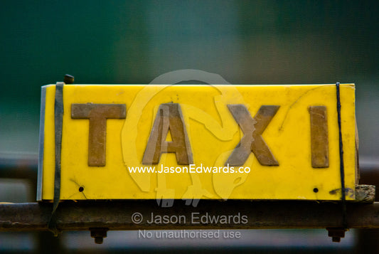 A taxi sign on the roof of a vehicle in a village at the intersection of several Himalayan highways. Wangdi, Wangdue Phodrang, Wangdue Phodrang District, Bhutan.