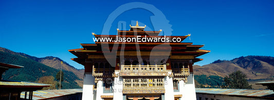 The ornate eaves and intricately carved balcony facades of an ancient Buddhist monastery. Gangteng Monastery, Ganteng, Wangdue Phodrang District, Phobjika Valley, Phobjikha Valley, Gangteng Valley, Black Mountains, Bhutan.