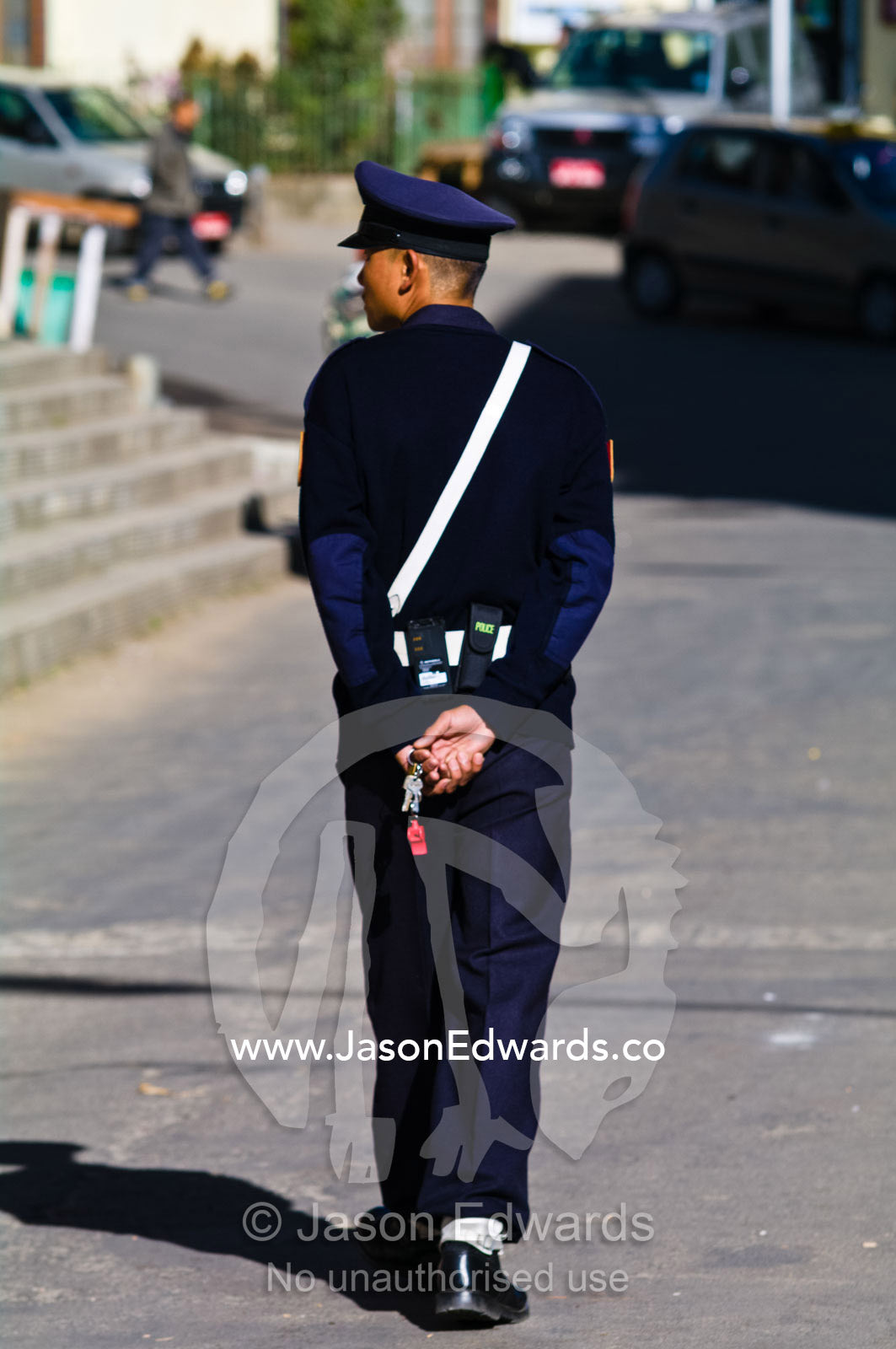 A traffic policeman patrolling the streets of a Himalayan town with his whistle. Thimphu, Thimphu District, Bhutan.