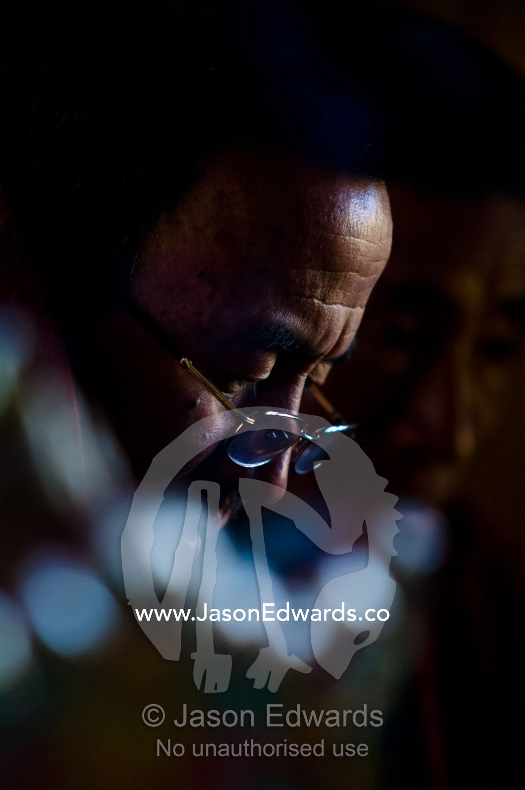 A Buddhist monk chanting sanskrit words during a death ceremony in a Bhutanese home. Ganteng, Wangdue Phodrang District, Phobjika Valley, Phobjikha Valley, Gangteng Valley, Black Mountains, Bhutan.