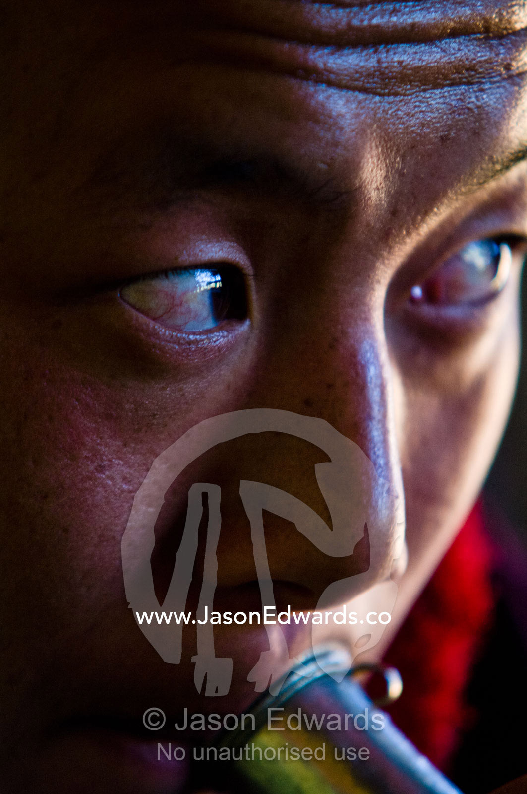 A Buddhist monk plays a kangling, a flute made from a human femur bone at a death ceremony in a private home. Ganteng, Wangdue Phodrang District, Phobjika Valley, Phobjikha Valley, Gangteng Valley, Black Mountains, Bhutan.