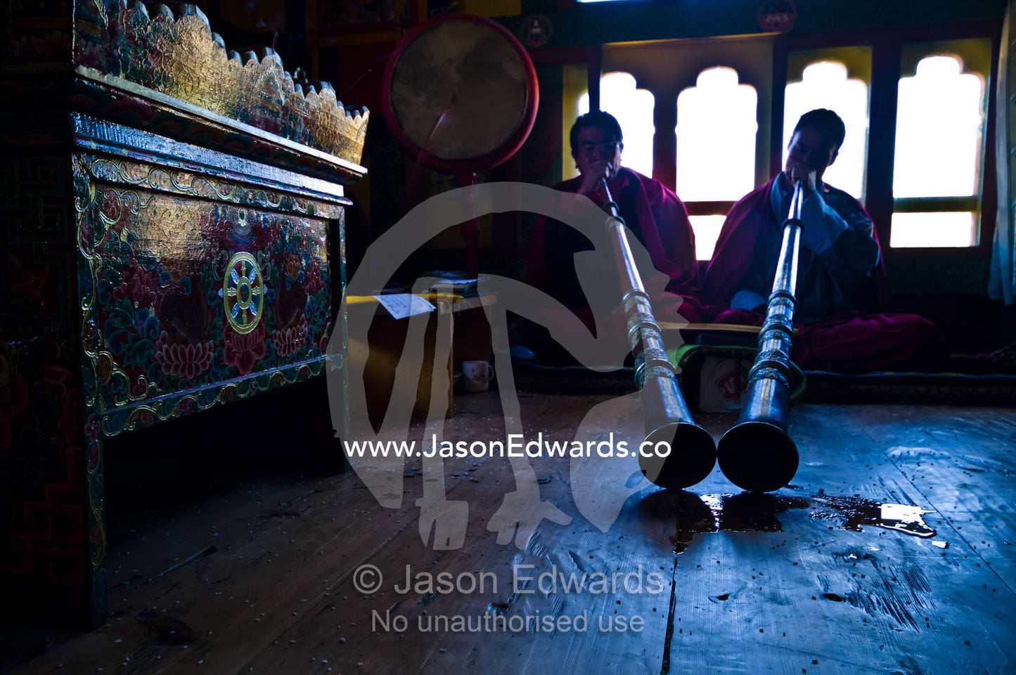 Pools of saliva gather at the ends of dungchen horns played by Buddhist monks at a death ceremony in a Bhutanese home. Ganteng, Wangdue Phodrang District, Phobjika Valley, Phobjikha Valley, Gangteng Valley, Black Mountains, Bhutan.