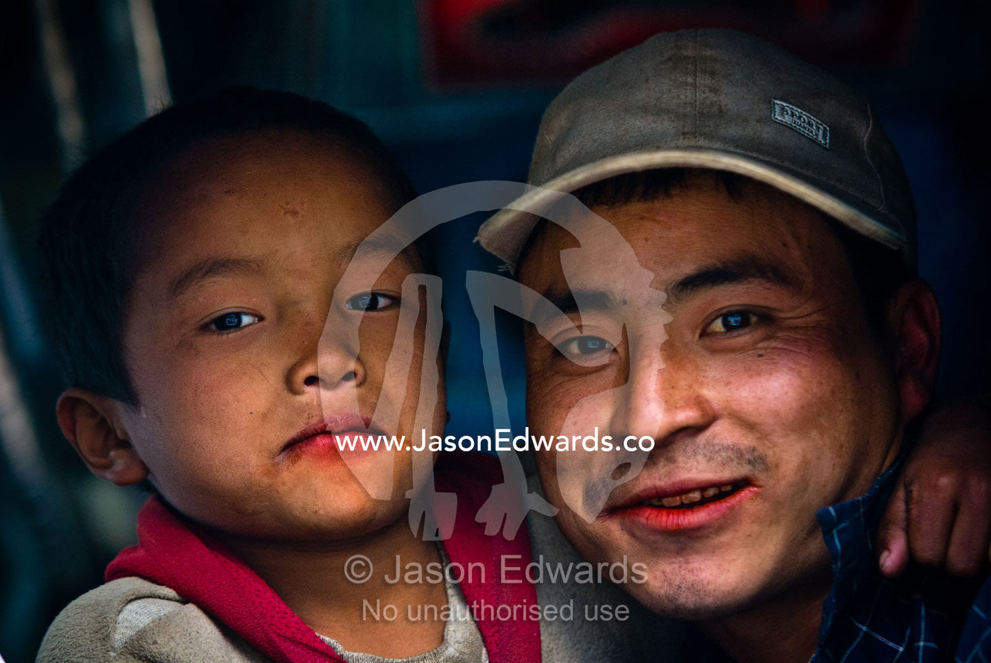 A truck driver and his son refueling their vehicle in a village at the intersection of several Himalayan highways. Wangdi, Wangdue Phodrang, Wangdue Phodrang District, Bhutan.