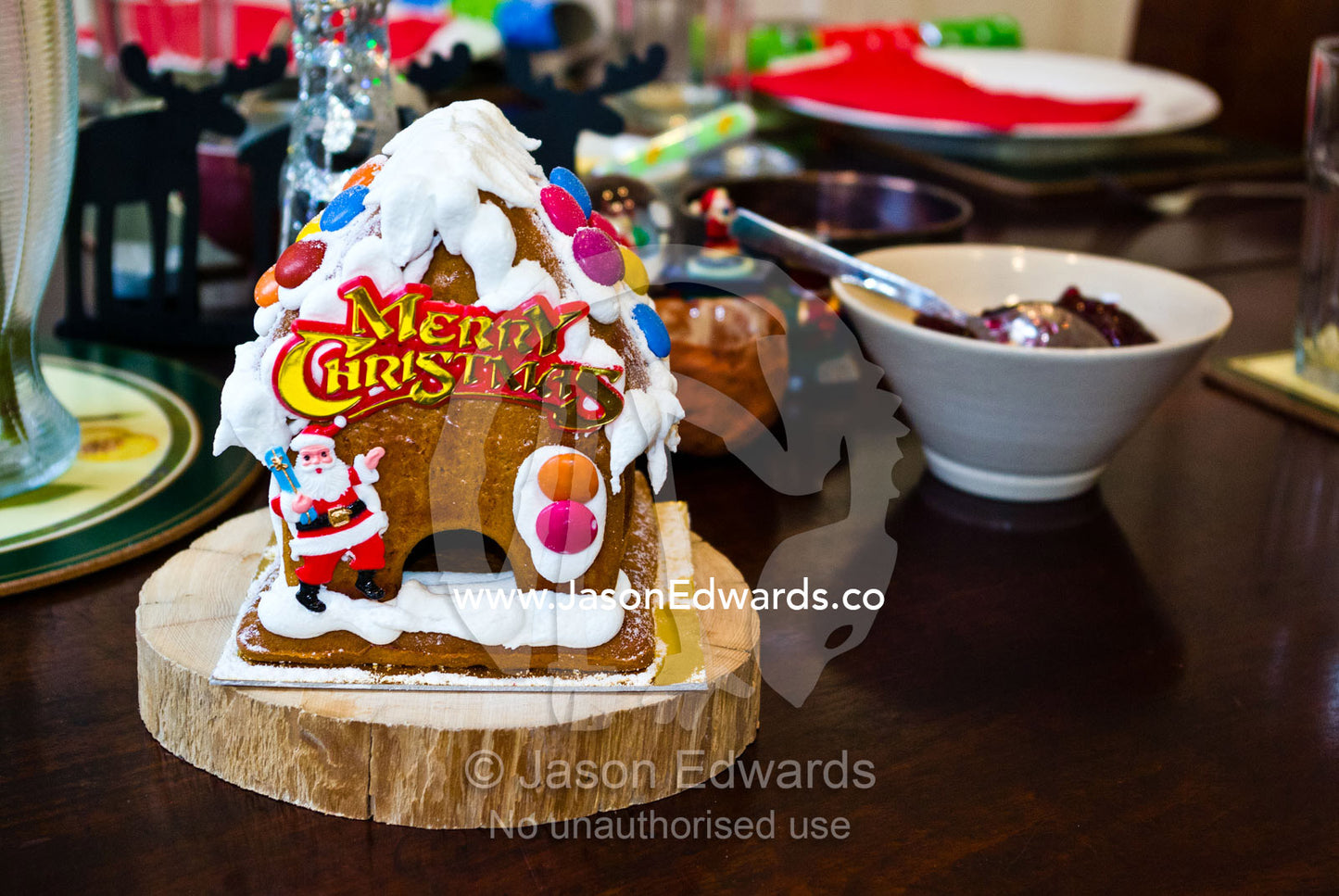 A gingerbread house with Father Christmas and snow candy roof. Carlton North, Melbourne, Victoria, Australia.