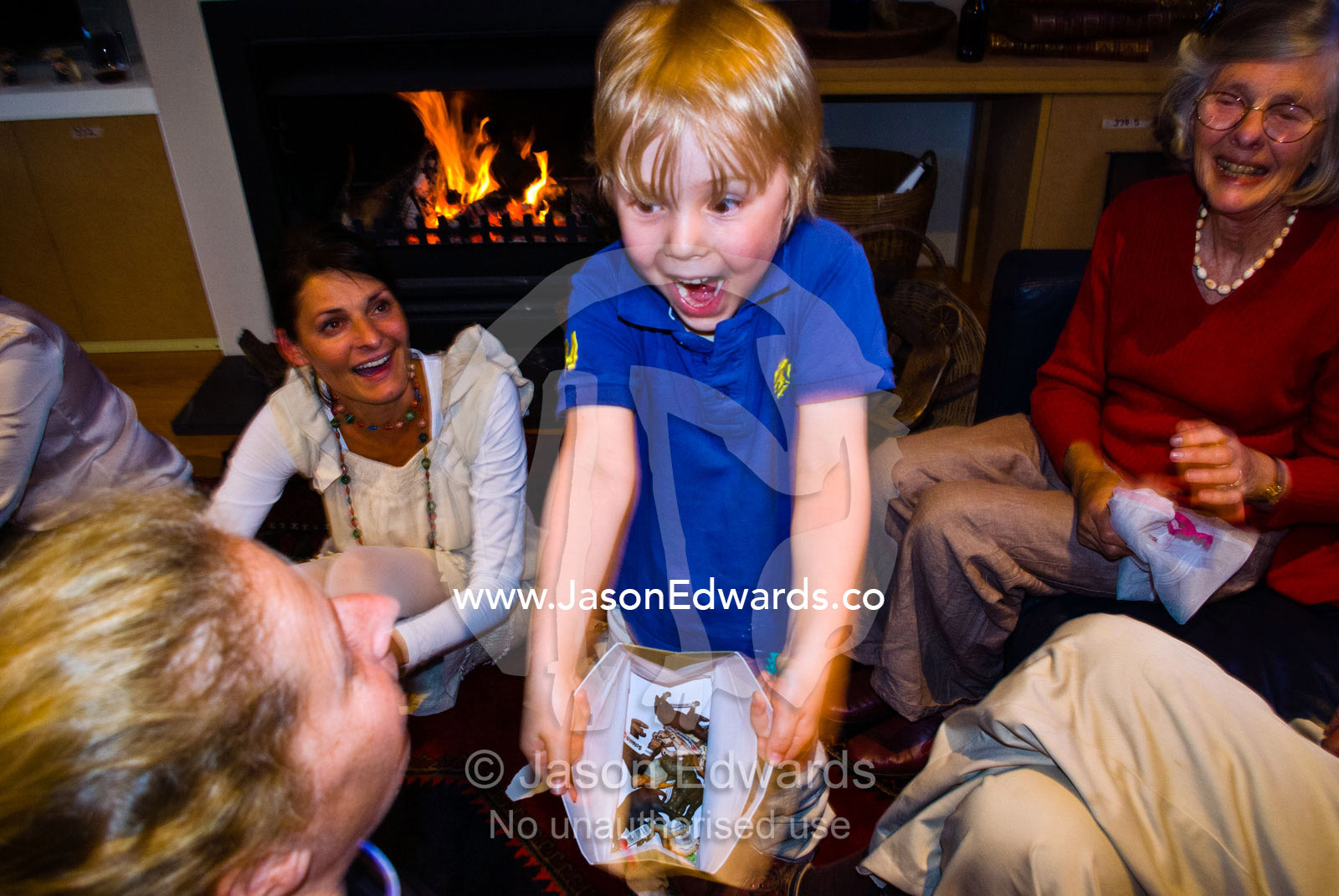An excited boy shows his mother his African animal toy christmas gift. Malvern East, Melbourne, Victoria, Australia.