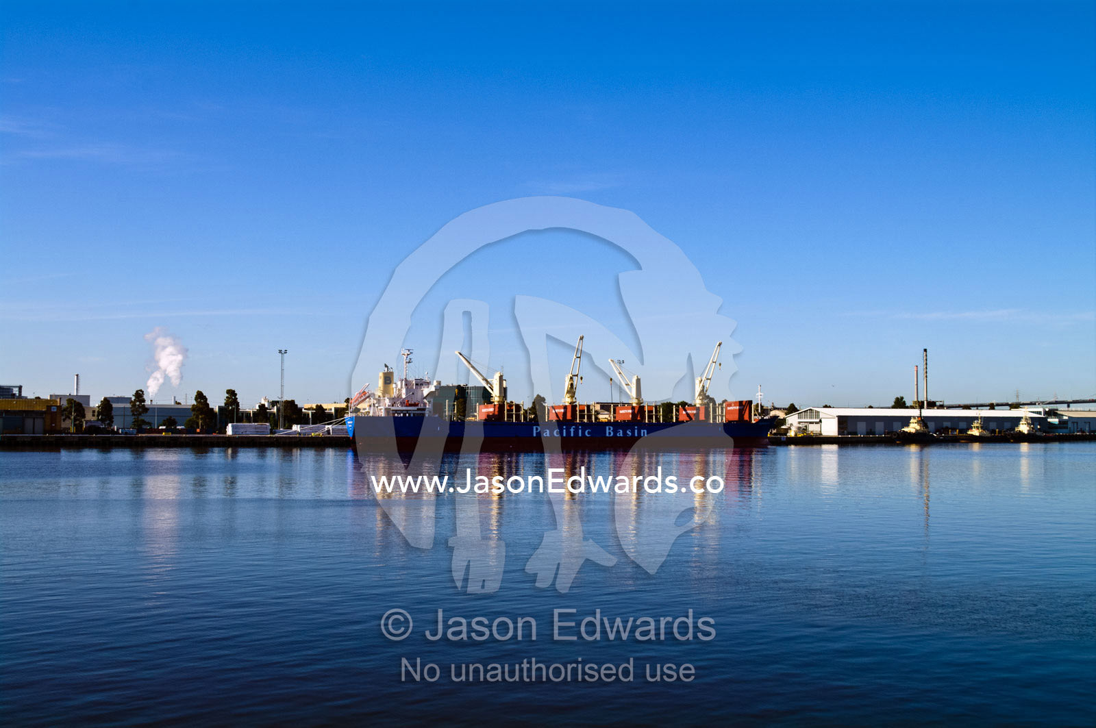 A cargo ship at a dock to be loaded with with shipping containers. Yarra River, Appleton Dock, Port of Melbourne, West Melbourne, Victoria, Australia.