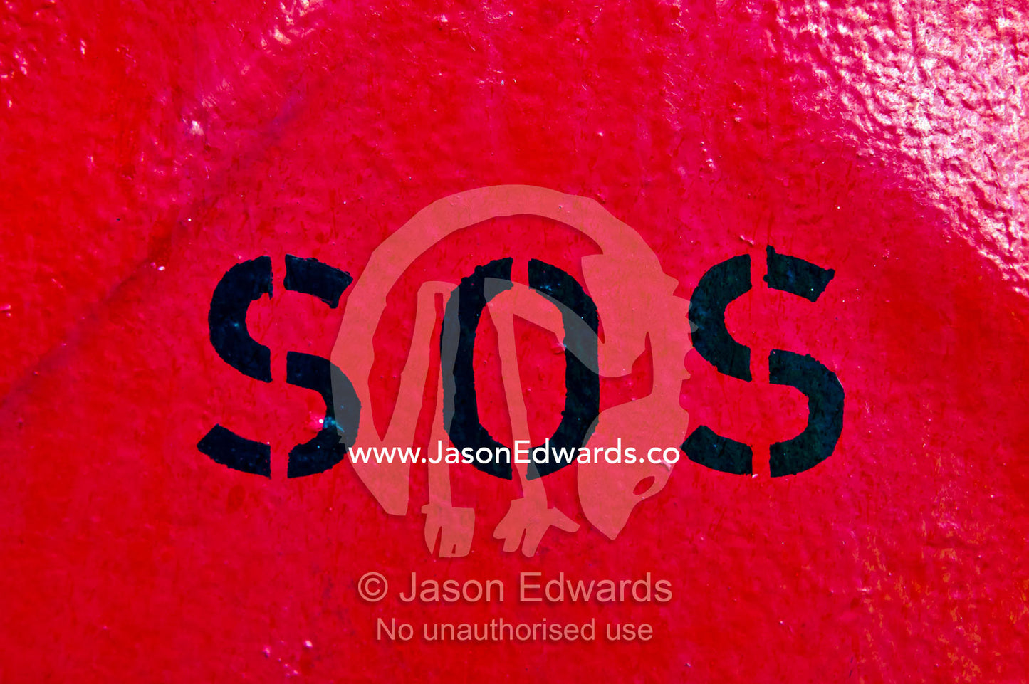 Emergency SOS stencil sign on a bright red steel wall on a cargo ship. Appleton Dock, Port of Melbourne, West Melbourne, Victoria, Australia.